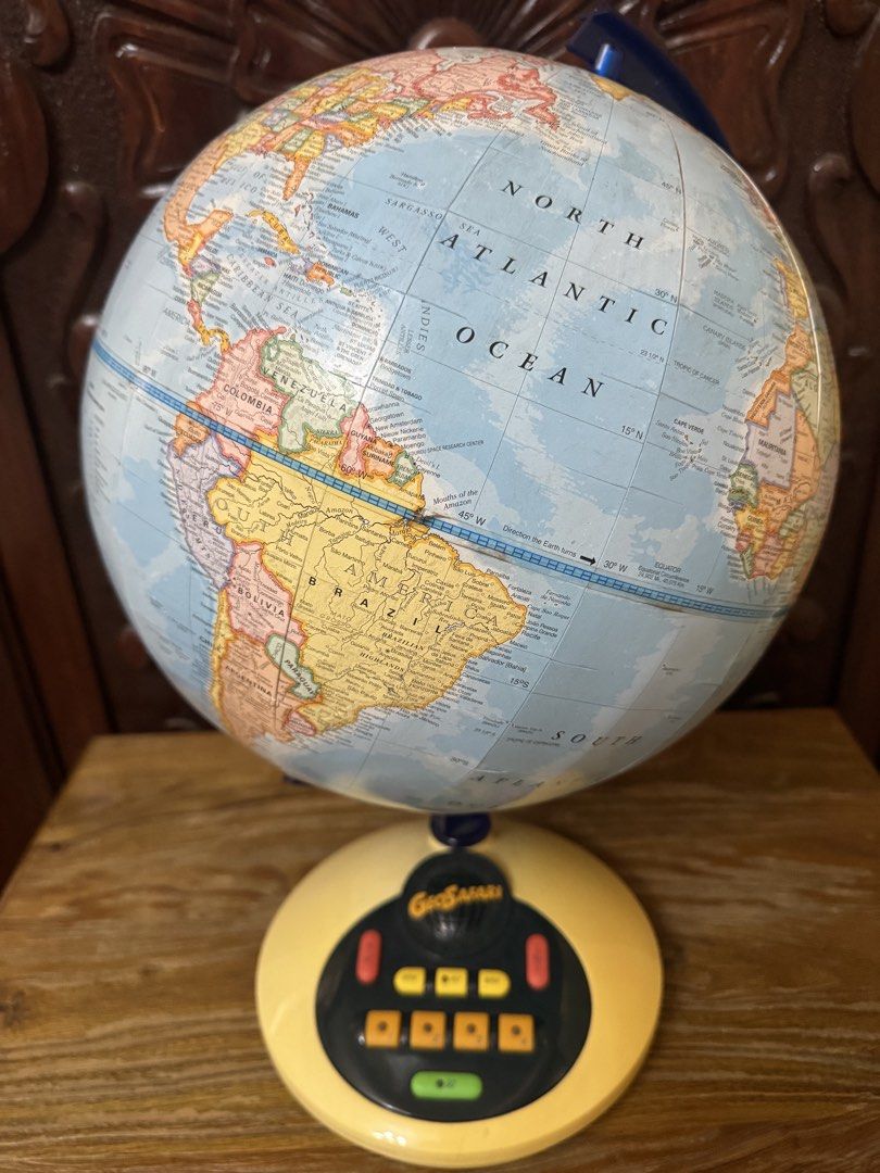 GeoSafari Interactive Talking Globe Geographic Learning Toy (Category: Educational & Learning Toys) located in Las Pinas. Submitted by emdjss (Listing ID 1470781285, Image 1). Description: - GeoSafari interactive talking globe by George F. Cram Co. - Blue ocean design featuring colorful country maps - Yellow plastic base with built-in control buttons (GO, REPEAT, HELP, and category buttons) - Battery-operated interactive quiz system for fun learn