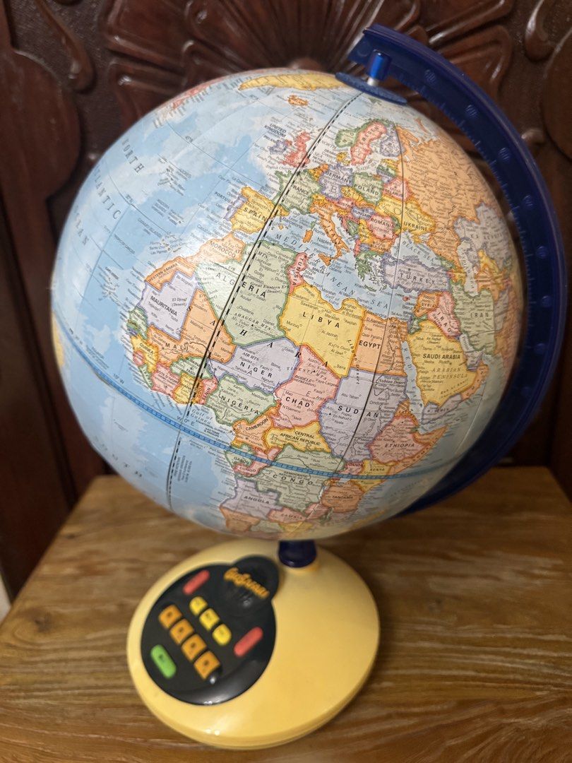 GeoSafari Interactive Talking Globe Geographic Learning Toy (Category: Educational & Learning Toys) located in Las Pinas. Submitted by emdjss (Listing ID 1470781285, Image 3). Description: - GeoSafari interactive talking globe by George F. Cram Co. - Blue ocean design featuring colorful country maps - Yellow plastic base with built-in control buttons (GO, REPEAT, HELP, and category buttons) - Battery-operated interactive quiz system for fun learn
