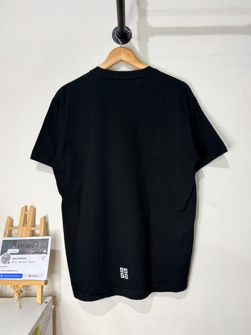 Givenchy Black Graphic Tee (Category: Activewear) located in Caloocan City. Submitted by choidelfin.420 (Listing ID 1470825997, Image 2). Description: - Brand: Givenchy - Color: Black - Style: Classic fit, crew neck, short sleeves - Design: Large distressed 4G logo on chest with white brand lettering - Detail: Small white logo patch on the lower back hem - Condition: Good casual wear option - Size: Large.