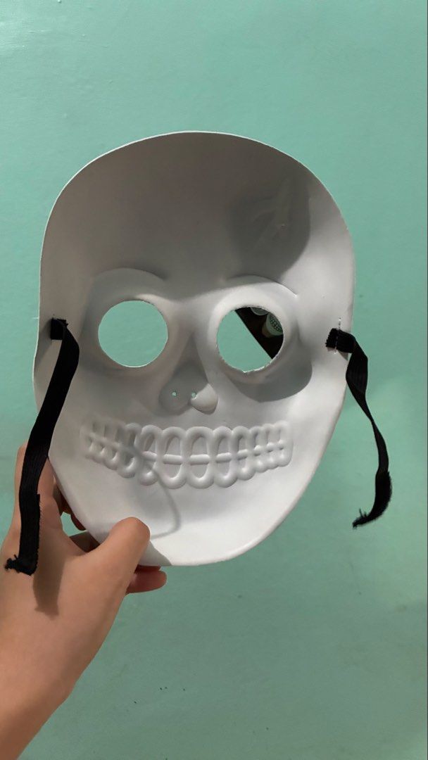 Glow in the dark skull mask (Category: Occasions & Party Supplies) located in Manila. Submitted by dukejah (Listing ID 1470808971, Image 2). Description: - Condition: Brand new with original tag attached - Design: White skull with black cartoon-style eyes and teeth - Special Feature: Glows in the dark - Material: Lightweight plastic - Fit: Secure elastic black strap on both sides.