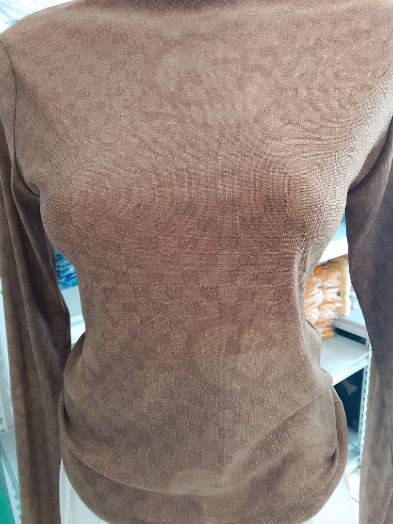 Gold Mesh Monogram Mock Neck Long Sleeve Top (Category: Longsleeves) located in Midsayap. Submitted by jarethshop (Listing ID 1470770350, Image 2). Description: - Color: Gold - Style: Fitted long sleeve with mock neck - Design: Subtle woven monogram pattern - Material: Thin, lightweight, and stretchy fabric - Versatility: Great for easy layering or wearing on its own.