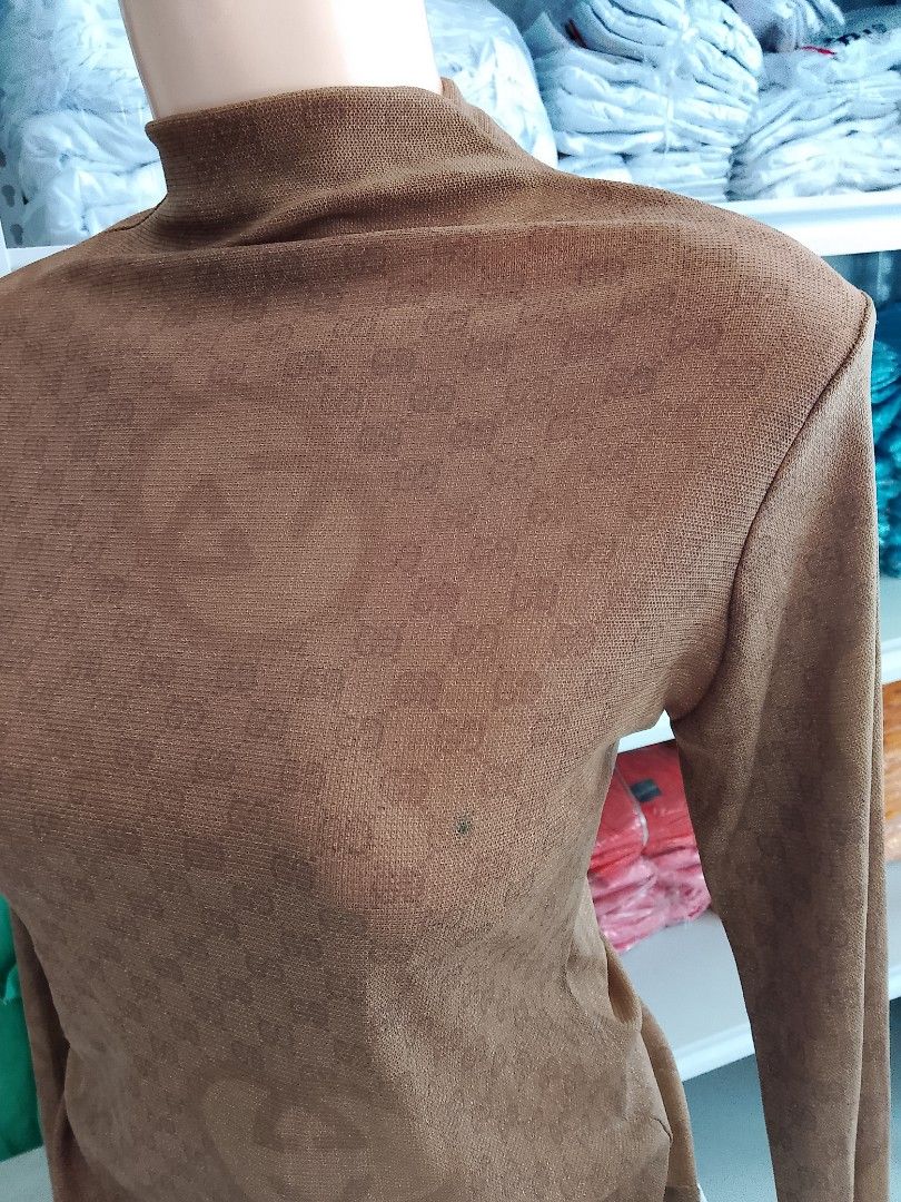 Gold Mesh Monogram Mock Neck Long Sleeve Top (Category: Longsleeves) located in Midsayap. Submitted by jarethshop (Listing ID 1470770350, Image 3). Description: - Color: Gold - Style: Fitted long sleeve with mock neck - Design: Subtle woven monogram pattern - Material: Thin, lightweight, and stretchy fabric - Versatility: Great for easy layering or wearing on its own.