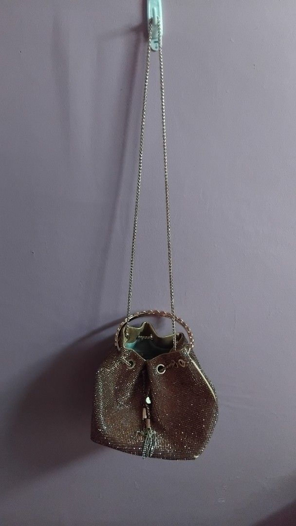 GOLD RHINESTONE BUCKET BAG (Category: Purses & Pouches) located in Iloilo. Submitted by ayinscloset (Listing ID 1470790993, Image 2). Description: ✨ GOLD RHINESTONE BUCKET BAG FOR SALE Price: ₱650 (Negotiable) Condition: Preloved - Elegant champagne gold color - Sparkling rhinestone design - Stylish circular top handle - Long chain strap for shoulder or crossbody use - Drawstring-style closure - Interior zippered pocket - Perfect for parties, wed