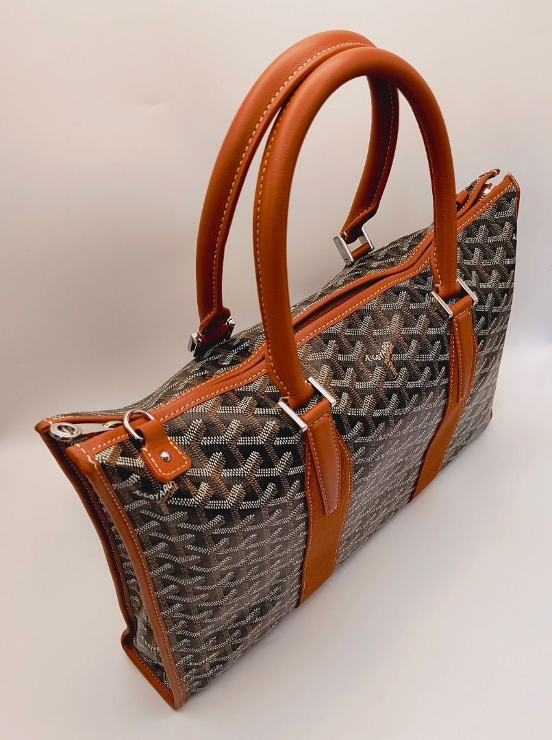 Goyard Morvan Document Case Black Tan Bag (Category: Luxury Bags & Wallets) located in Cebu City. Submitted by affordabagss (Listing ID 1470770661, Image 2). Description: Goyard Morvan PM Document Case crafted in black and tan Goyardine canvas with Chevroches calfskin leather trim and silver-tone hardware. Features the signature Goyard chevron pattern, double rounded leather top handles, and detachable shoulder strap. Finished with a slim, struct