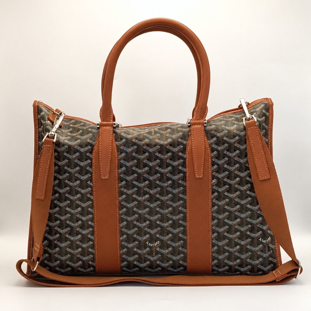 Goyard Morvan Document Case Black Tan Bag (Category: Luxury Bags & Wallets) located in Cebu City. Submitted by affordabagss (Listing ID 1470770661, Image 3). Description: Goyard Morvan PM Document Case crafted in black and tan Goyardine canvas with Chevroches calfskin leather trim and silver-tone hardware. Features the signature Goyard chevron pattern, double rounded leather top handles, and detachable shoulder strap. Finished with a slim, struct