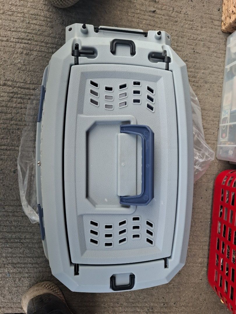 Grey and blue plastic pet carrier box (Category: Storage Boxes & Baskets) located in Manila. Submitted by rocksolid227 (Listing ID 1470776486, Image 3). Description: - Color: Grey top with dark blue bottom and matching handle - Condition: Overall clean, minimal signs of handling - Ventilation: Multiple slots across body and top lid for optimal airflow - Security: Sturdy blue carrying handle and secure latch closures - Ideal for: Vet visits and tr