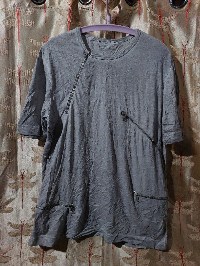 Grey asymmetric zipper t-shirt (Category: Tshirts & Polo Shirts ) located in Caloocan City. Submitted by shikiibun (Listing ID 1470775540, Image 2). Description: - Color: Grey - Material: 100% Cotton (Made in Turkey) - Design: Crew neck, short sleeves with unique asymmetric hem - Details: Industrial hardware zippers and functional zipped pockets - Condition: Excellent / Like new - Perfect for an edgy, streetwear look.