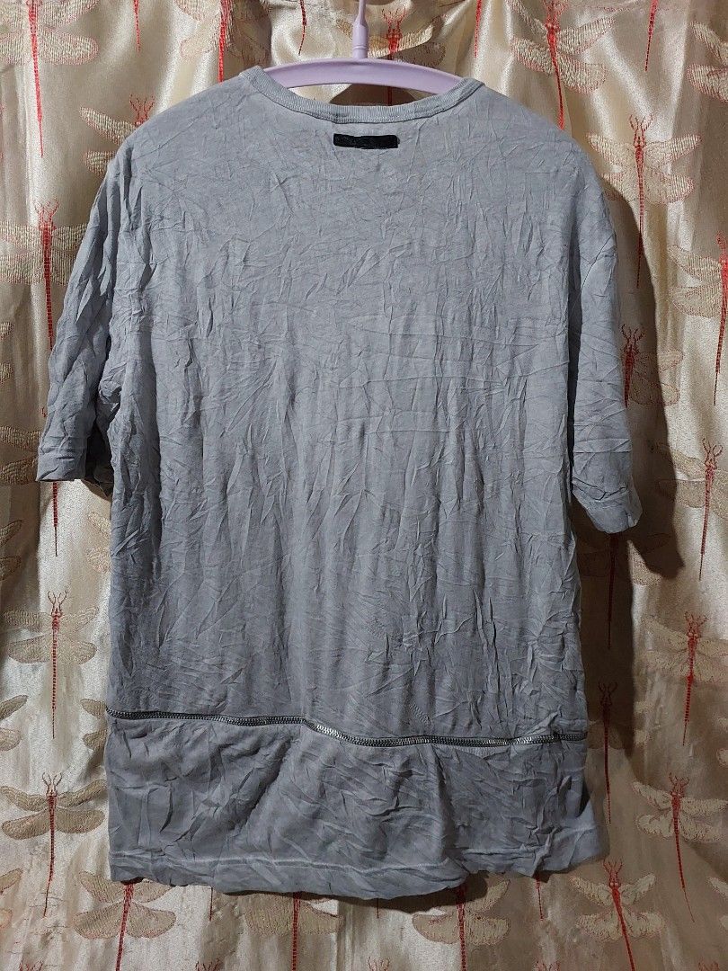 Grey asymmetric zipper t-shirt (Category: Tshirts & Polo Shirts ) located in Caloocan City. Submitted by shikiibun (Listing ID 1470775540, Image 3). Description: - Color: Grey - Material: 100% Cotton (Made in Turkey) - Design: Crew neck, short sleeves with unique asymmetric hem - Details: Industrial hardware zippers and functional zipped pockets - Condition: Excellent / Like new - Perfect for an edgy, streetwear look.