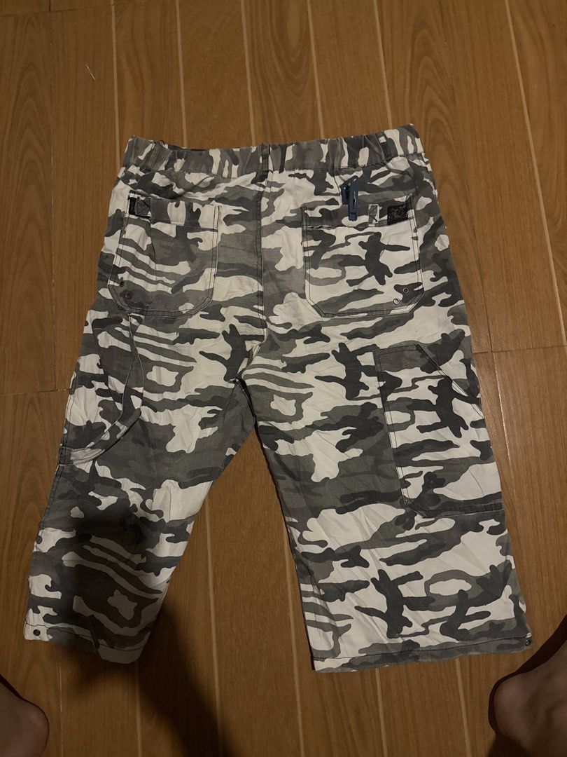 Grey camouflage cargo jorts (Category: Shorts) located in Calamba. Submitted by xacalixa (Listing ID 1470840134, Image 2). Description: - Style: Grey camouflage cargo shorts with a baggy, knee-length fit - Material: Sturdy, high-quality cotton - Features: Multiple utility flap pockets, secure button closure, and elastic waistband in the back for extra comfort - Condition: Worn a few times, washed clean, and ready to wear - Perfect for: Casual str