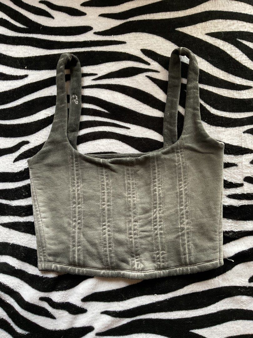 Grey corset style tank top crop top (Category: Sleeveless) located in Baguio. Submitted by prelovedbymb_11 (Listing ID 1470870351, Image 1). Description: - Style: Sleeveless crop top with square neckline - Details: Structured vertical seams and thick straps - Material: Soft jersey fabric with a faded, vintage wash - Fit: Cropped length, perfect with high-waisted bottoms - Condition: Worn a few times, no damage.