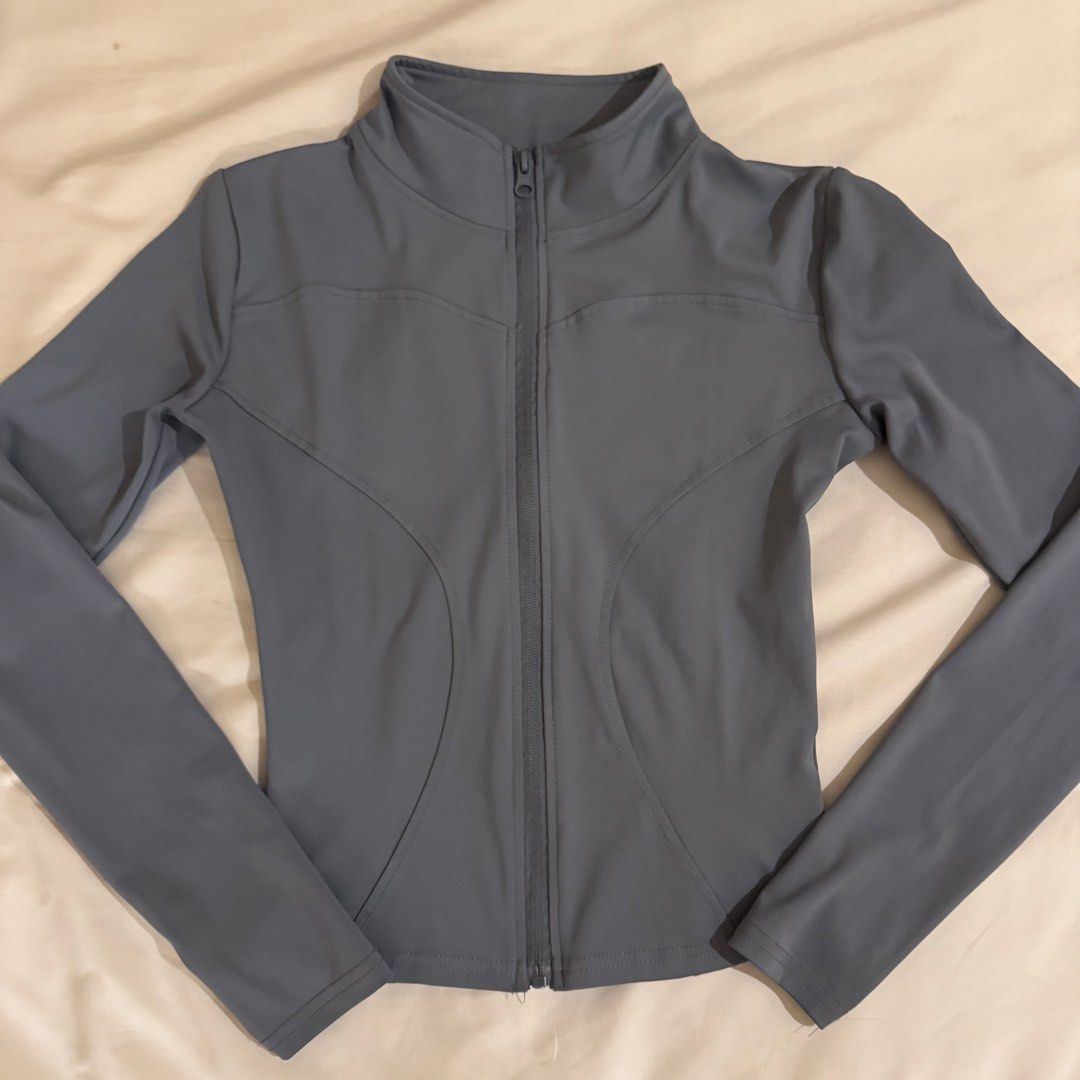 Grey Long-Sleeve Activewear Zip-Up Jacket (Category: Coats, Jackets and Outerwear) located in Quezon City. Submitted by s0l4nge (Listing ID 1470885671, Image 2). Description: - Style: Grey activewear zip-up jacket - Fit: Fitted cut with flattering contoured front seam lines - Design: High collar and full-length front zipper - Material: Smooth, comfortable athletic fabric - Condition: Excellent / Ready to wear.