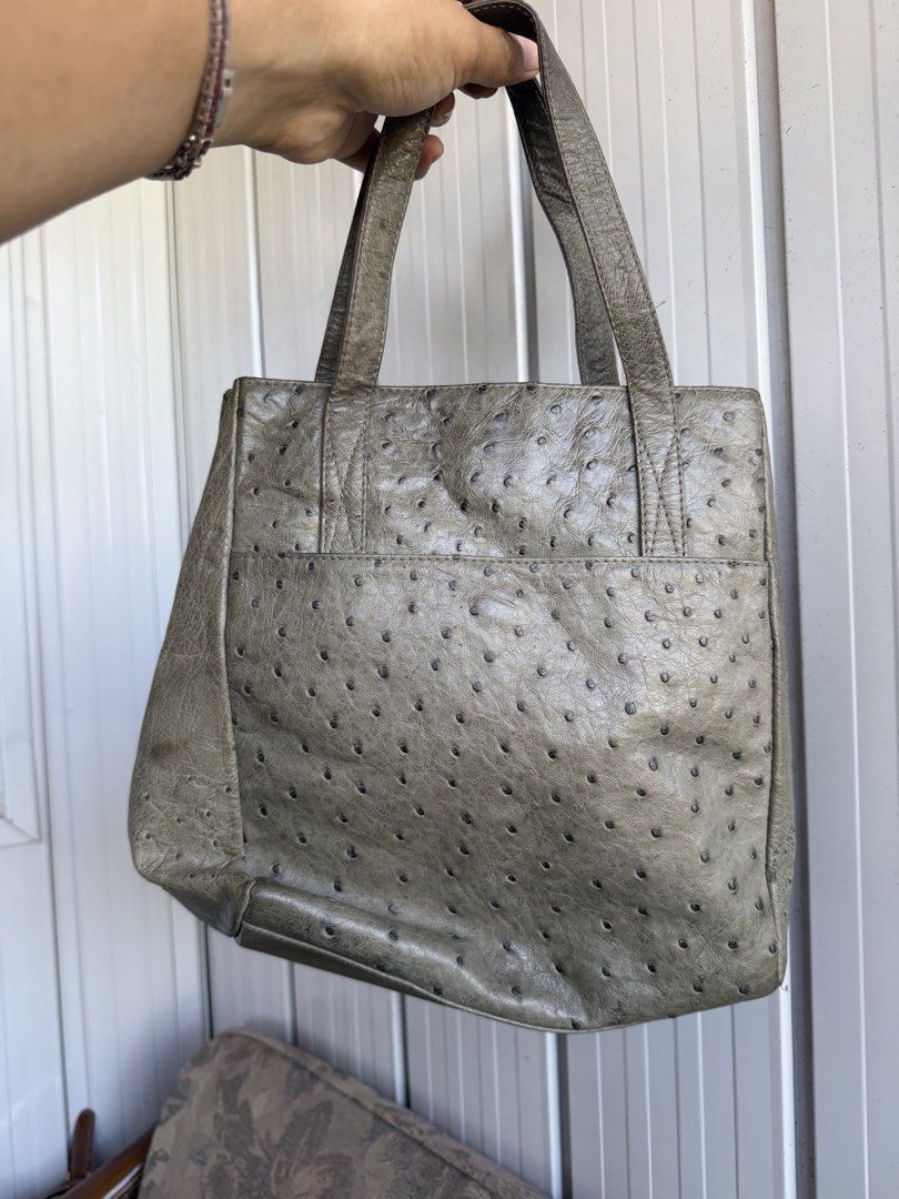 Grey textured leather tote handbag with double handles (Category: Tote Bags) located in Digos. Submitted by old_soul. (Listing ID 1470802264, Image 2). Description: - Style: Grey textured leather tote - Handles: Double top handles for easy carrying - Closure: Open top with secure magnetic snap - Interior: Black lining with multiple zippered compartments and slip pockets - Condition: Clean structure with plenty of room for daily essentials - RUSH 