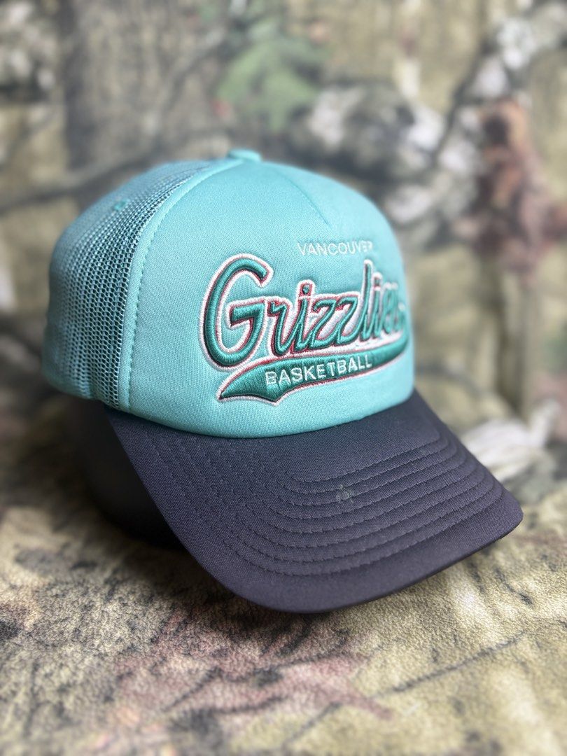 Grizzlies Trucker Cap (Category: Caps & Hats) located in Manila. Submitted by josh2295 (Listing ID 1470755737, Image 1). Description: teal and black Mitchell & Ness Vancouver Grizzlies trucker snapback cap featuring an embroidered script team logo.