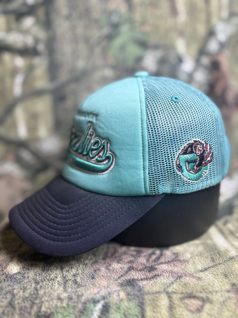 Grizzlies Trucker Cap (Category: Caps & Hats) located in Manila. Submitted by josh2295 (Listing ID 1470755737, Image 2). Description: teal and black Mitchell & Ness Vancouver Grizzlies trucker snapback cap featuring an embroidered script team logo.