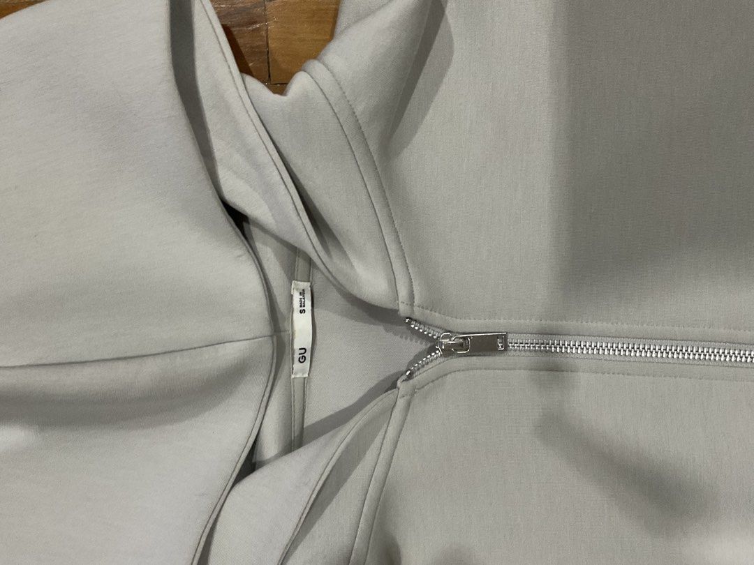 GU Light Grey Zip-Up Hoodie Size S (Category: Coats, Jackets and Outerwear) located in Manila. Submitted by bnyonyo (Listing ID 1470797363, Image 2). Description: - Brand: GU - Color: Light grey - Size: S (tag attached near collar) - Material: Smooth cotton blend - Closure: Full metal zipper - Condition: Clean all around - Style: Simple everyday basic layer.
