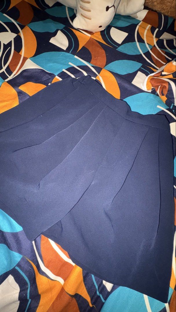 GU Navy Blue Pleated Shorts (Category: Shorts) located in Munoz. Submitted by joanadelara (Listing ID 1470839345, Image 2). Description: - Brand: GU - Color: Navy blue - Design: Classic solid color with stylish front pleats - Waistband: Comfortable elastic waistband - Pockets: Two back pocket details - Style: Versatile and easy to match with various tops for casual days.