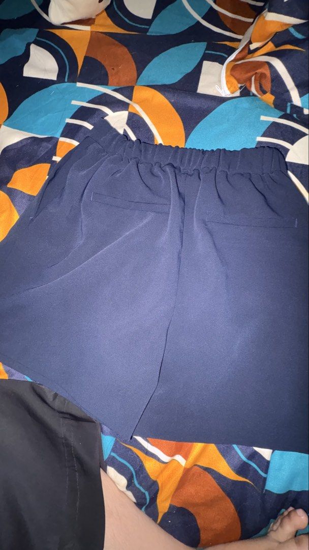 GU Navy Blue Pleated Shorts (Category: Shorts) located in Munoz. Submitted by joanadelara (Listing ID 1470839345, Image 3). Description: - Brand: GU - Color: Navy blue - Design: Classic solid color with stylish front pleats - Waistband: Comfortable elastic waistband - Pockets: Two back pocket details - Style: Versatile and easy to match with various tops for casual days.