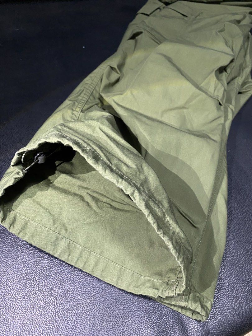 GU Olive Green Cargo Pants Size S (Category: Jeans) located in Las Pinas. Submitted by boldbear_89ab40 (Listing ID 1470827740, Image 3). Description: - Brand/Model: GU Olive Green Cargo Pants - Size: S - Material: 64% Polyester, 36% Cotton blend - Waistband: Elastic with button closure - Pockets: Functional side pockets and utility cargo pockets - Hem: Adjustable drawstring at the ankles - Condition: Great casual everyday wear.