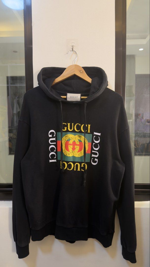 Gucci Black Hoodie (Category: Coats, Jackets and Outerwear) located in Paranaque City. Submitted by preluxeshop_ph (Listing ID 1470796944, Image 2). Description: Gucci Black Hoodie - Bold multicolored logo graphic on the chest - Size: L (tag attached) - Crafted in Italy - Features adjustable drawstring hood, ribbed cuffs, and hem - Excellent Condition.