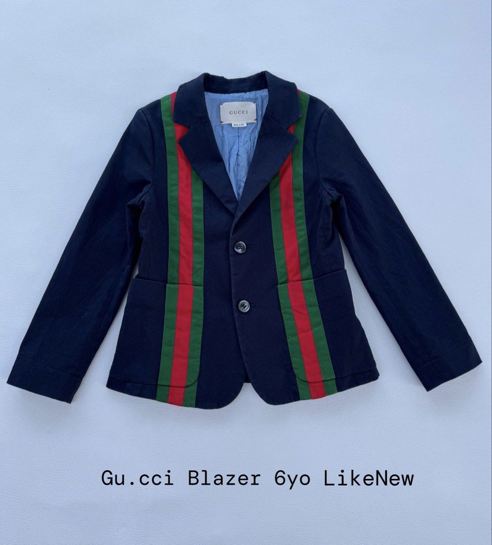 Gucci Kids Navy Blazer with Web Stripe (Category: Babies & Kids Fashion) located in Pozorrubio. Submitted by izaykite2g (Listing ID 1470772492, Image 1). Description: - Authentic Gucci navy blue blazer for kids (Age 6) - Iconic green and red web stripes down the front - Classic designer tailoring with sharp lapels - Two functional front pockets and dark center buttons - Premium light blue inner lining - Clean fabric, well-maintained, and ready to