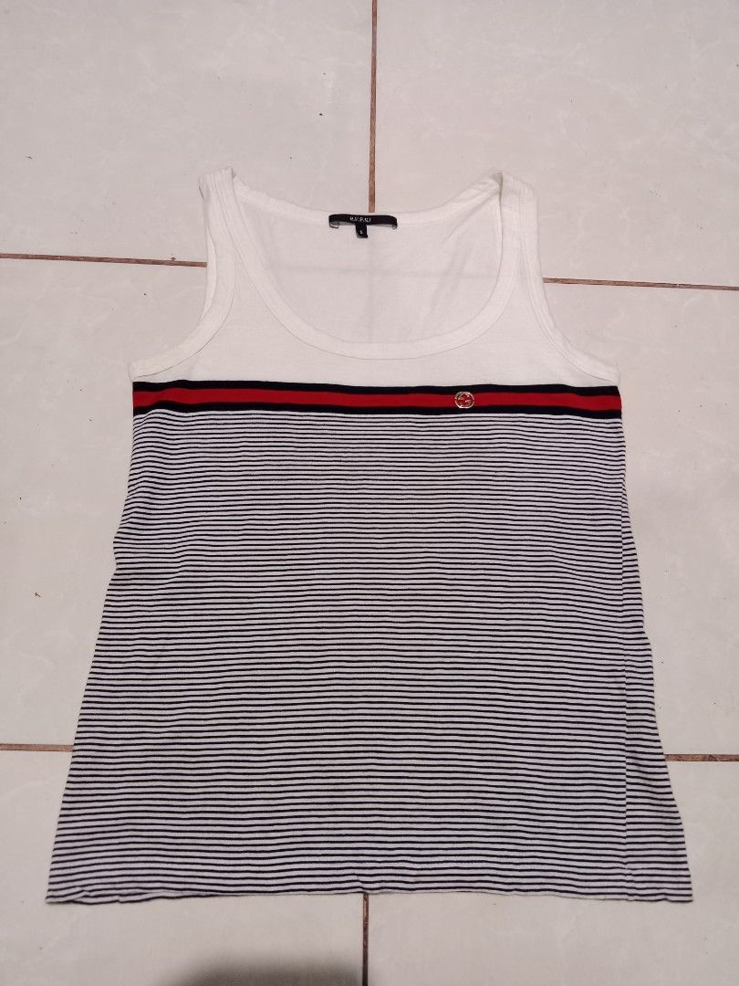 Gucci Striped Tank Top Size S (Category: Sleeveless) located in Bacolod City. Submitted by jorengrate26639 (Listing ID 1470843308, Image 1). Description: - Authentic Gucci white tank top - Iconic blue and red web stripe across the chest - Features signature Interlocking G metal hardware emblem - Scoop neck, sleeveless summer style - Size: S (tag attached at inner collar).