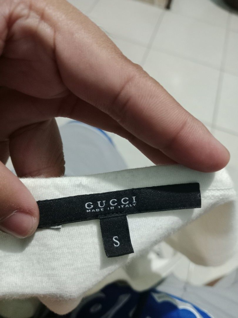 Gucci Striped Tank Top Size S (Category: Sleeveless) located in Bacolod City. Submitted by jorengrate26639 (Listing ID 1470843308, Image 3). Description: - Authentic Gucci white tank top - Iconic blue and red web stripe across the chest - Features signature Interlocking G metal hardware emblem - Scoop neck, sleeveless summer style - Size: S (tag attached at inner collar).