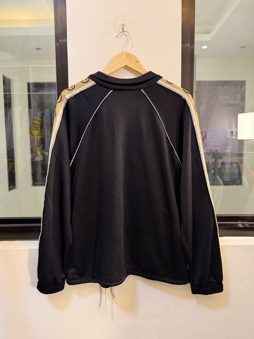 Gucci Technical Zip-Up Track Jacket (Category: Coats, Jackets and Outerwear) located in Paranaque City. Submitted by preluxeshop_ph (Listing ID 1470817263, Image 3). Description: Brand: Gucci •Style: Technical Zip-Up Track Jacket / Sweatshirt •Color: Black with cream/white trim and beige GG side taping •Design Features: Signature GG monogram logo tape along both sleeves, white piped trim accents, full-zip front closure with double contrast zip li