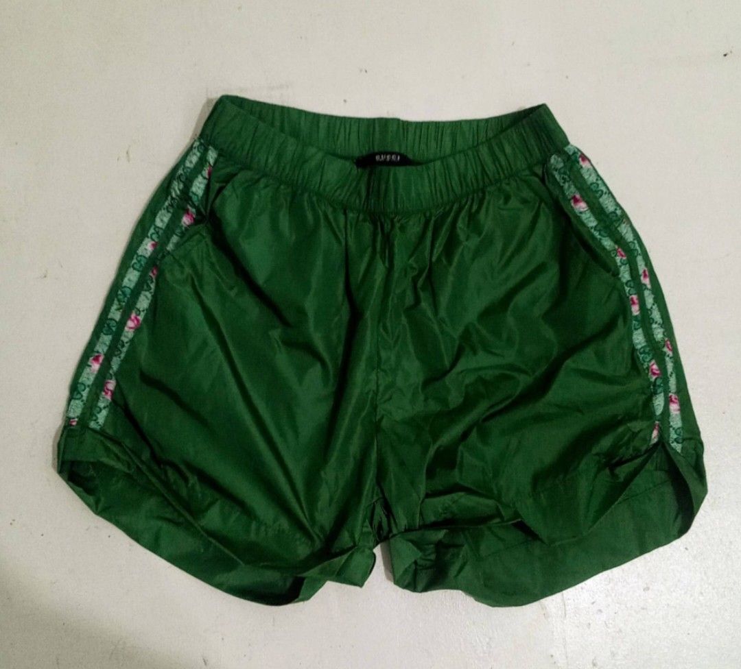 GUCCI Womens Nylon Shorts (Category: Luxury Apparel) located in Manila. Submitted by eriiicaspage (Listing ID 1470840120, Image 1). Description: PreOwned LikeNew Lightly Used Gucci Green Nylon Shorts - Item: Green Nylon Shorts - Size: 38 Medium (M) - Material: Lightweight nylon - Features: Elastic waistband, convenient side pockets, and back welt pockets - Design: Distinctive floral and green striped taping down the sides - Origin: Made in Italy 