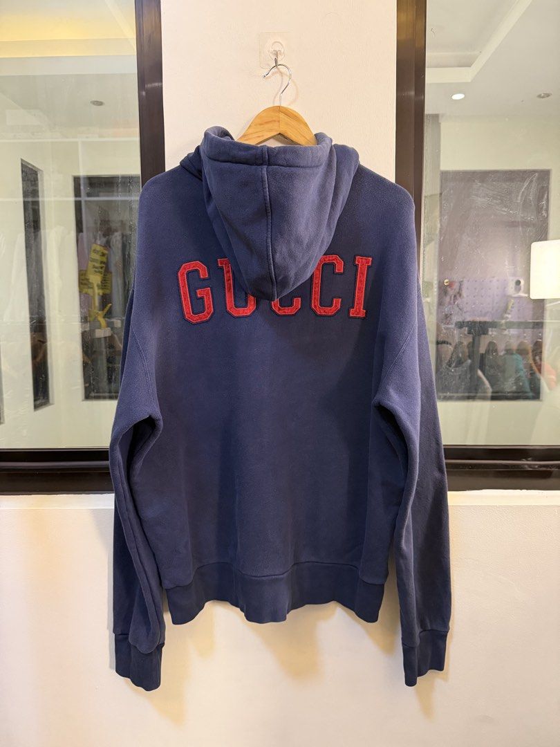 Gucci x MLB Full-Zip Hooded Sweatshirt (Category: Coats, Jackets and Outerwear) located in Paranaque City. Submitted by preluxeshop_ph (Listing ID 1470816434, Image 3). Description: Brand: Gucci x MLB (New York Yankees Collaboration) •Style: Full-Zip Hooded Sweatshirt / Zip Hoodie •Color: Navy Blue •Design Features: Large off-white “NY” Yankees appliqué patch on the front, embroidered red “GUCCI” arc logo across the upper back, full front zip clo