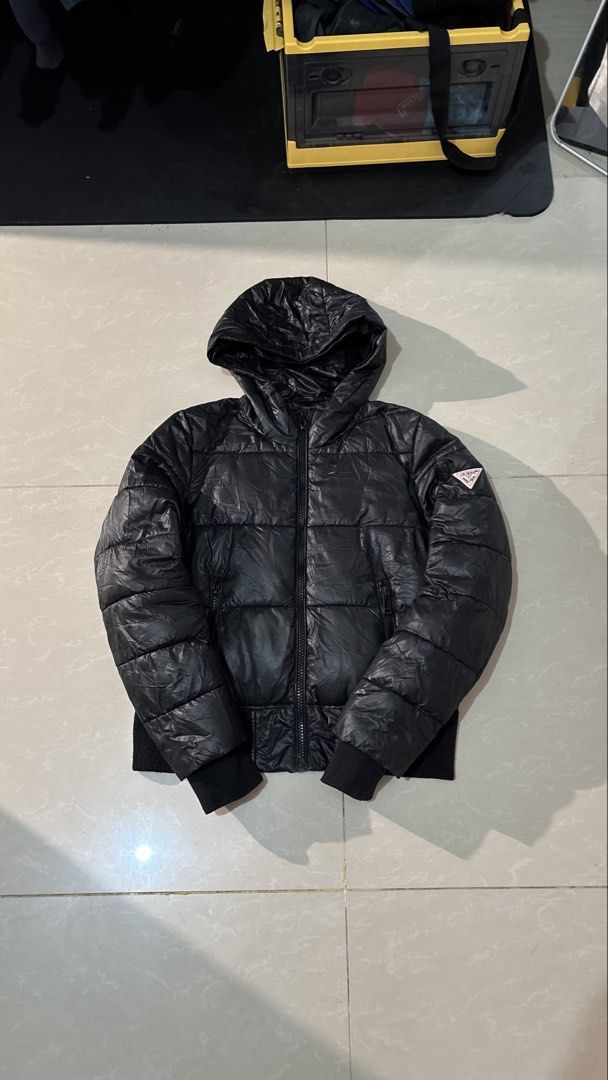 Guess Black Puffer Jacket with Hood Size S (Category: Coats, Jackets and Outerwear) located in Manila. Submitted by glano (Listing ID 1470860554, Image 1). Description: - Brand: Guess - Color: Black - Size: S (tag attached near collar) - Condition: Brand new / Excellent - Style: Lightweight hooded puffer jacket - Closure: Full front zip with branded zipper pull - Pockets: Two secure zippered side pockets - Branding: Iconic Guess triangle logo pat