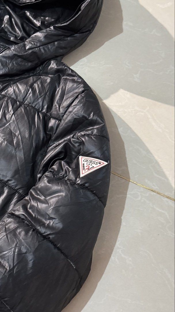 Guess Black Puffer Jacket with Hood Size S (Category: Coats, Jackets and Outerwear) located in Manila. Submitted by glano (Listing ID 1470860554, Image 2). Description: - Brand: Guess - Color: Black - Size: S (tag attached near collar) - Condition: Brand new / Excellent - Style: Lightweight hooded puffer jacket - Closure: Full front zip with branded zipper pull - Pockets: Two secure zippered side pockets - Branding: Iconic Guess triangle logo pat