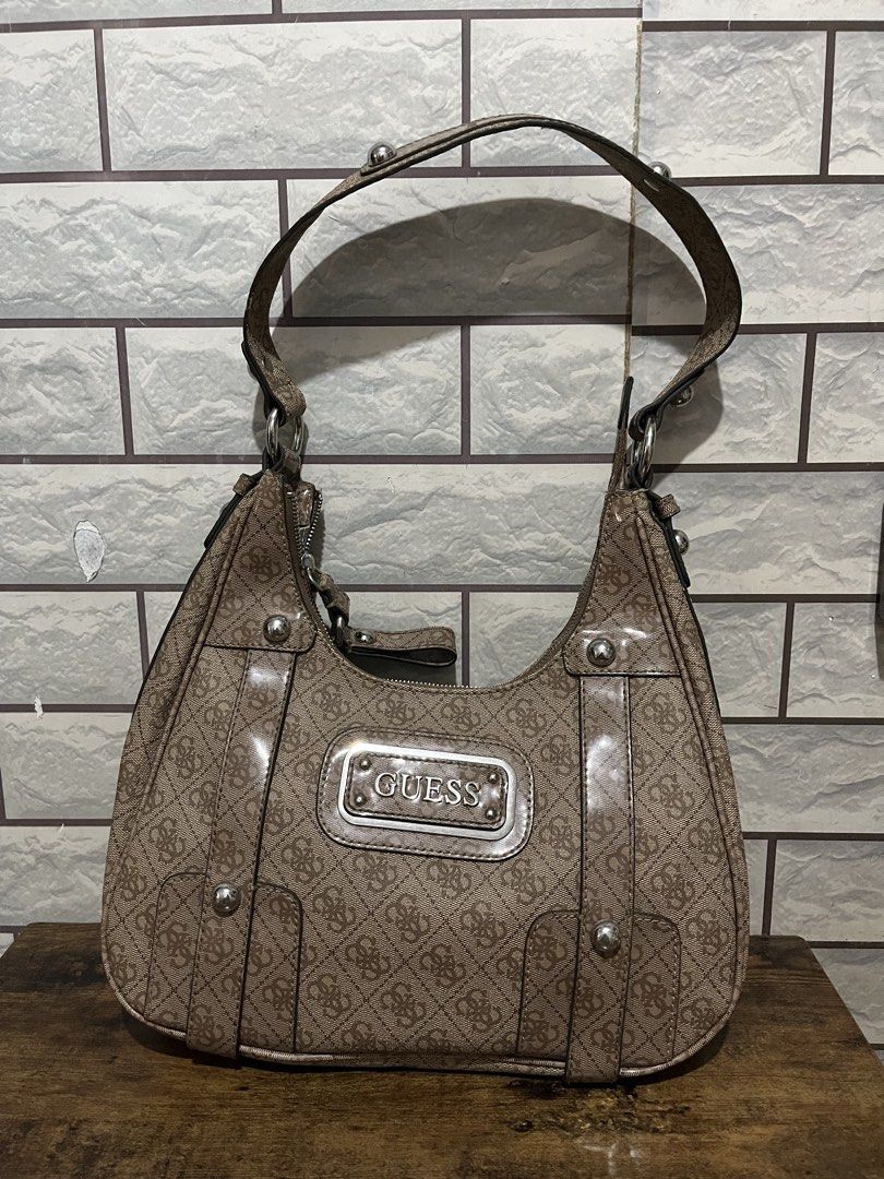 Guess Brown Monogram Shoulder Bag with Silver Hardware (Category: Shoulder Bags) located in Manila. Submitted by kuya_erick62 (Listing ID 1470760365, Image 1). Description: - Authentic Guess shoulder bag in classic brown monogram fabric - Sleek silver-tone hardware and iconic metal GUESS front logo plaque - Comfortable double shoulder straps accented with stylish stud details - Convenient exterior back zipper pocket for easy access to essentials 
