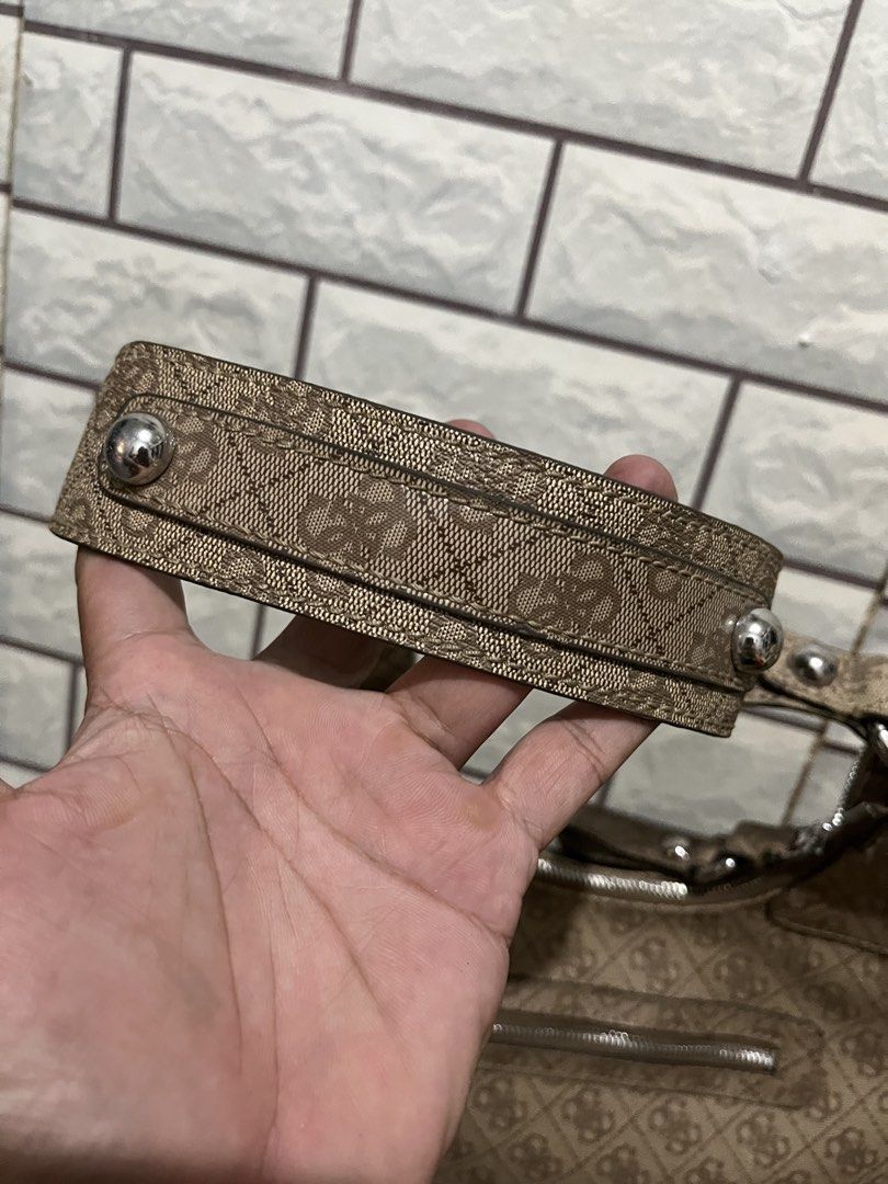 Guess Brown Monogram Shoulder Bag with Silver Hardware (Category: Shoulder Bags) located in Manila. Submitted by kuya_erick62 (Listing ID 1470760365, Image 3). Description: - Authentic Guess shoulder bag in classic brown monogram fabric - Sleek silver-tone hardware and iconic metal GUESS front logo plaque - Comfortable double shoulder straps accented with stylish stud details - Convenient exterior back zipper pocket for easy access to essentials 