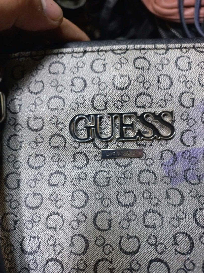 Guess Los Angeles Monogram Print Handbag (Category: Shoulder Bags) located in Quezon City. Submitted by dei03_diz (Listing ID 1470846021, Image 3). Description: - Authentic Guess Los Angeles handbag - Classic all-over monogram pattern with black faux leather trim - Silver-tone hardware and front metal logo plaque - Structured silhouette with secure zip closure - Spacious fabric-lined interior with inner pockets and branded metal tag - Flat base w