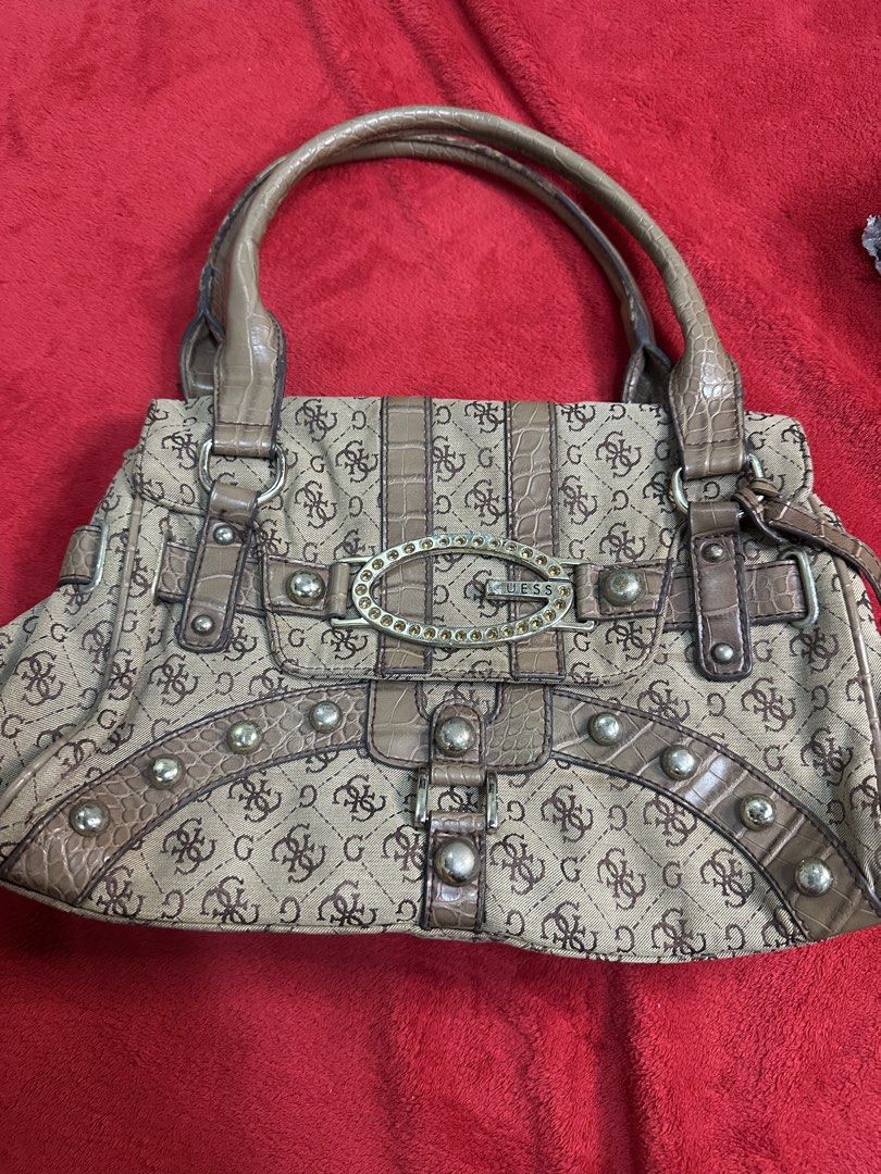 Guess monogram pattern shoulder bag with rhinestone logo (Category: Shoulder Bags) located in Manila. Submitted by goldenhorse-dafc (Listing ID 1470866866, Image 1). Description: - Brand: Guess - Color/Pattern: Beige canvas with brown monogram print - Design Details: Faux crocodile leather trim, studded accents, and rhinestone-embellished oval logo buckle - Handles: Double top handles - Interior: Cream satin lining with convenient zipper pockets 