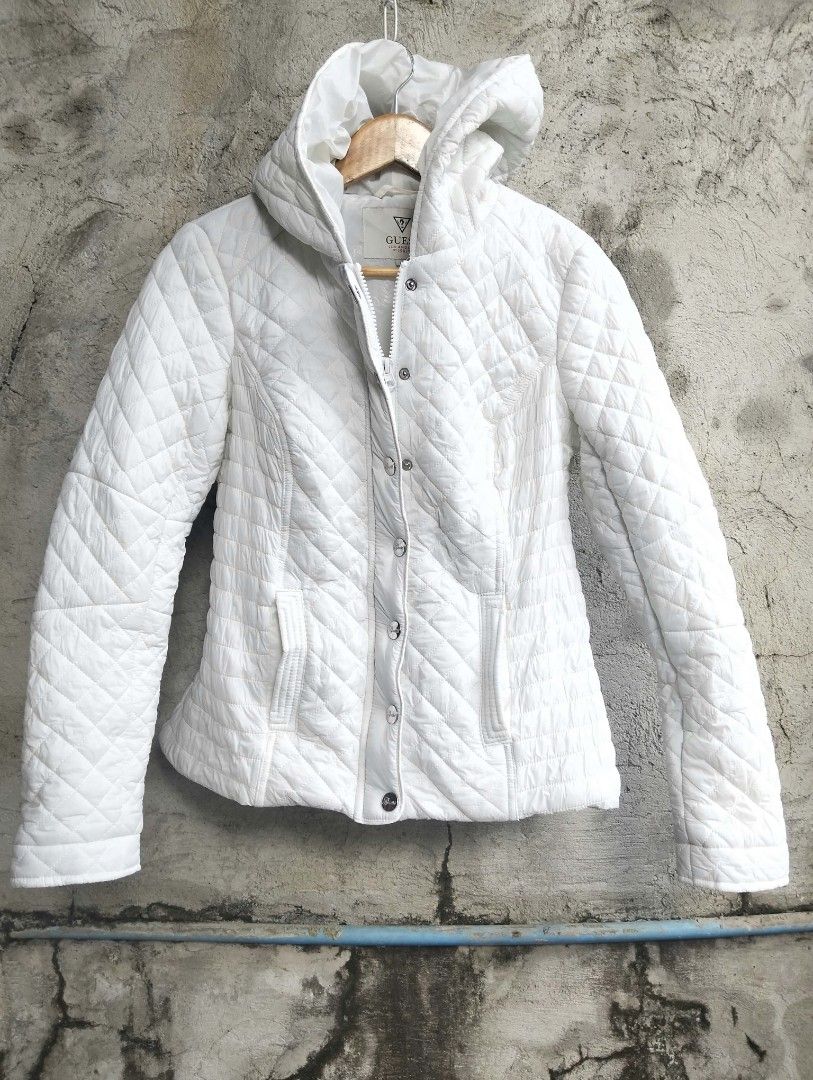 Guess White Quilted Hooded Puffer Jacket Size M (Category: Babies & Kids Fashion) located in Bulacan. Submitted by theroadthrift (Listing ID 1470931125, Image 1). Description: - Brand: Guess - Size: Med (KIDS) - Color: Classic White - Material: Nylon shell with quilted diamond pattern - Features: Hooded, front zipper with snap button closure, two front pockets - Condition: Great staple piece for cooler weather.