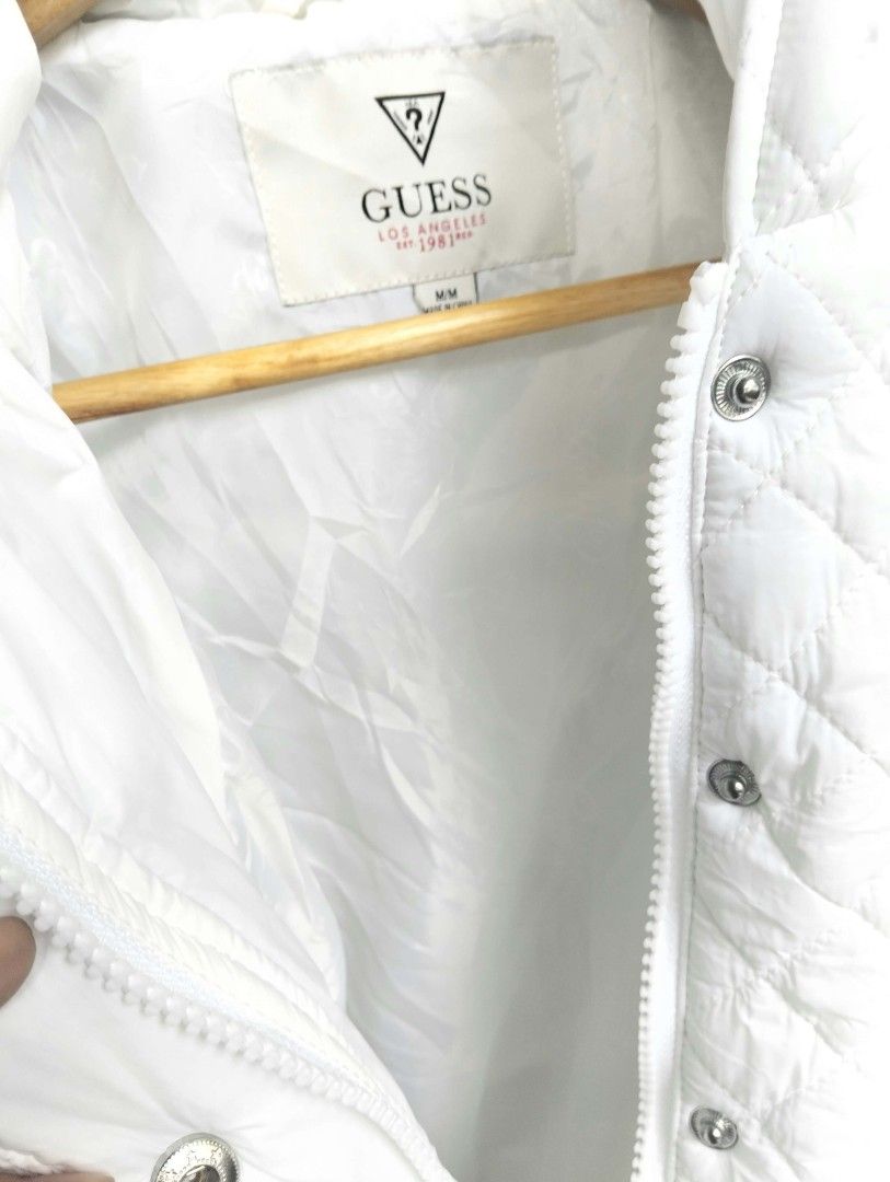 Guess White Quilted Hooded Puffer Jacket Size M (Category: Babies & Kids Fashion) located in Bulacan. Submitted by theroadthrift (Listing ID 1470931125, Image 3). Description: - Brand: Guess - Size: Med (KIDS) - Color: Classic White - Material: Nylon shell with quilted diamond pattern - Features: Hooded, front zipper with snap button closure, two front pockets - Condition: Great staple piece for cooler weather.