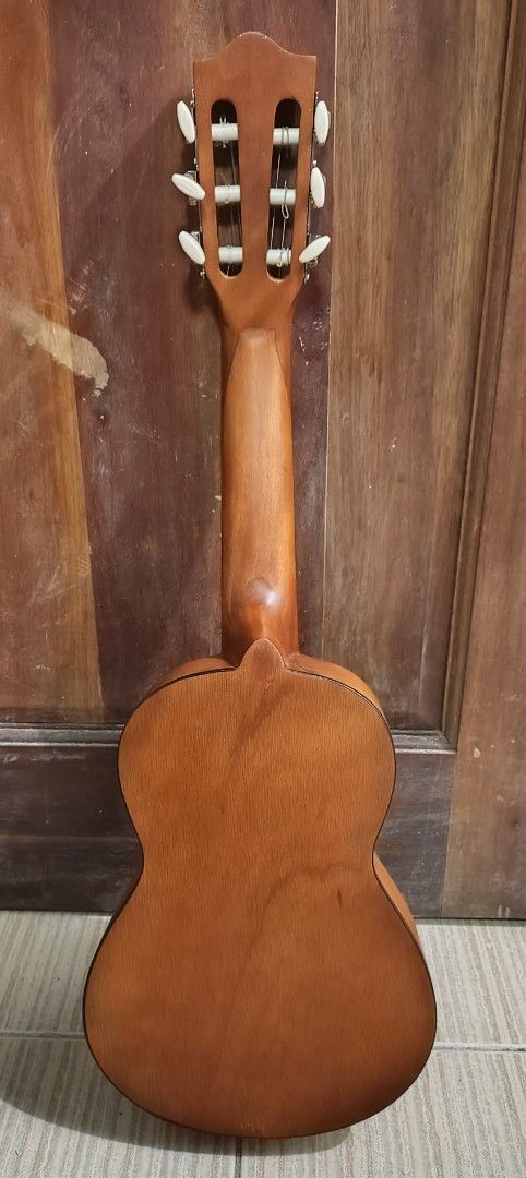 Guitale Guitarlele Classic Brown Mini Guitar (Category: Musical Instruments) located in Mandaluyong City. Submitted by kinergy04 (Listing ID 1470894861, Image 2). Description: - Guitalele Mini Classical Guitar - Color/Finish: Natural brown wooden finish - Hardware & Strings: Nylon strings with a classic slotted headstock - Design: Compact body shape, ideal for travel and practice on the go - Condition: Plays fine; note there is one small ding nea