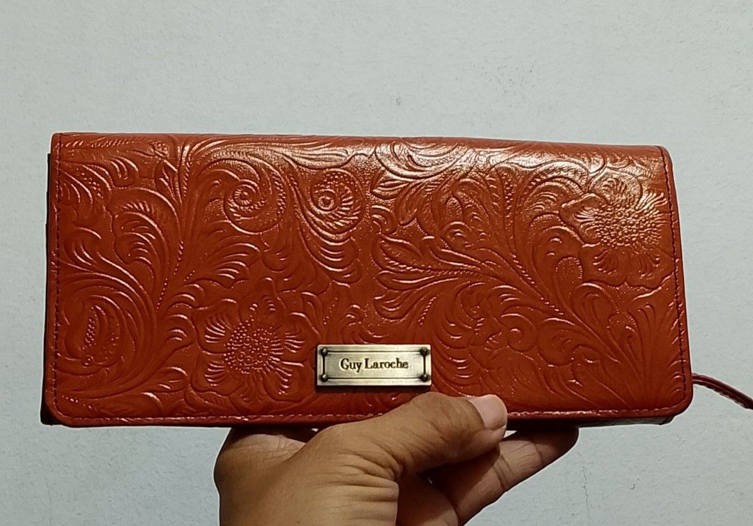 Guy Laroche Long Wallet (Category: Wallets & Card holders) located in Tarlac. Submitted by faithfulfinds (Listing ID 1470869964, Image 1). Description: Guy Laroche Embossed Floral Leather Long Wallet Lightly used & in excellent condition! Brand: Guy Laroche Design: Beautifully detailed embossed floral pattern Color: Classic reddish-brown / terracotta Condition: Lightly used. Shows minimal signs of usage, but completely unnoticeable when carried. 