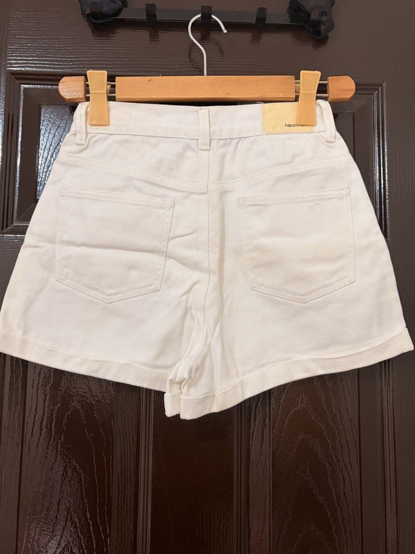 Haco share white denim cuffed shorts (Category: Shorts) located in Marikina City. Submitted by _bananahanaa (Listing ID 1470797042, Image 2). Description: - Brand: Haco Share - Color: Classic White - Fit: High-waisted with button closure - Details: Cuffed hem, front & back pockets, and a cute yellow brand patch at the back - Condition: Excellent / Clean look - size 26.