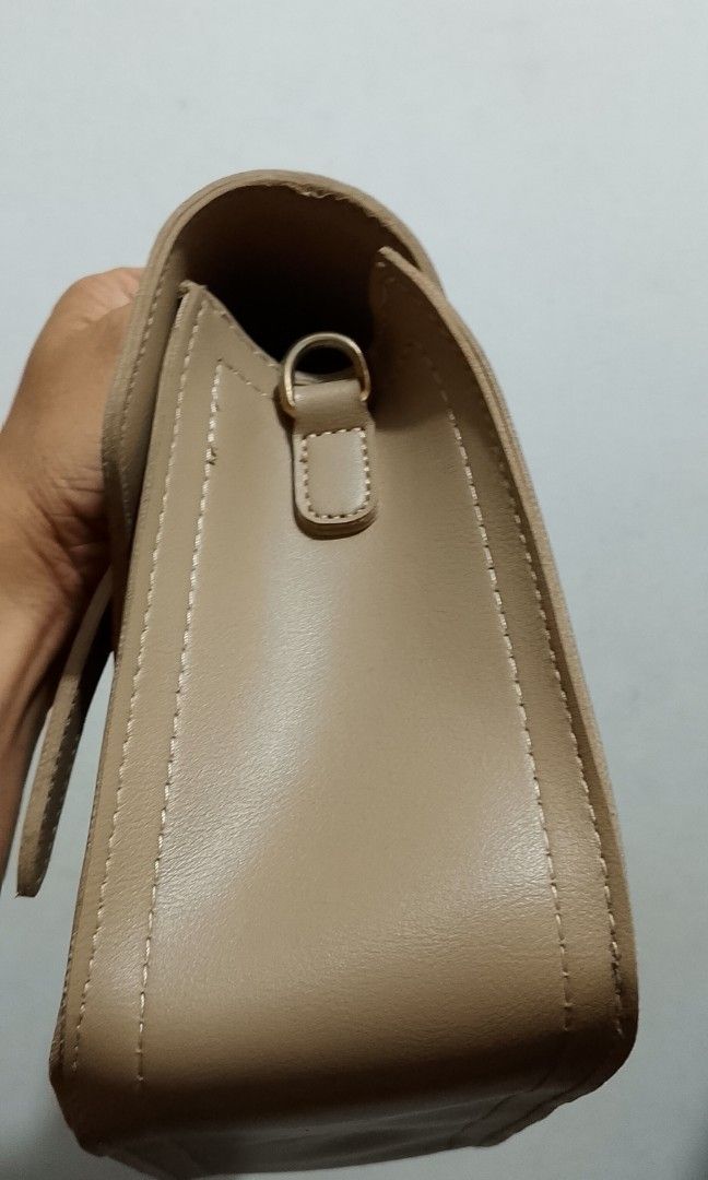 Handbag (Category: Clutches) located in Tarlac. Submitted by faithfulfinds (Listing ID 1470865849, Image 3). Description: Structured Satchel Bag (Taupe / Beige) -Excellent Condition -Lightly used with very minimal signs of wear -Clean interior and exterior ⚠️ Note: No long sling strap included (Selling as a top-handle bag only) Perfect everyday structured bag that adds a classy, elegant touch to any outfit!.