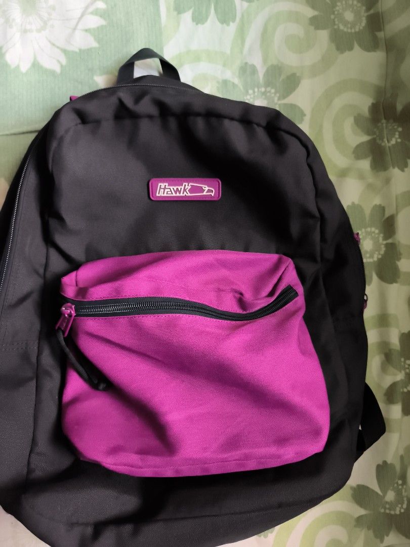 Hawk Black and Pink Backpack (Category: Backpacks) located in Bulacan. Submitted by jvblaguard08460 (Listing ID 1470750721, Image 2). Description: - Brand/Model: Hawk Backpack - Color: Classic black with a bright pink front pocket - Storage: Main compartment and front pocket with zipper closures - Comfort: Padded back straps for comfortable daily wear - Material: Durable fabric built to last - Use: Great size for school, work, or everyday commute
