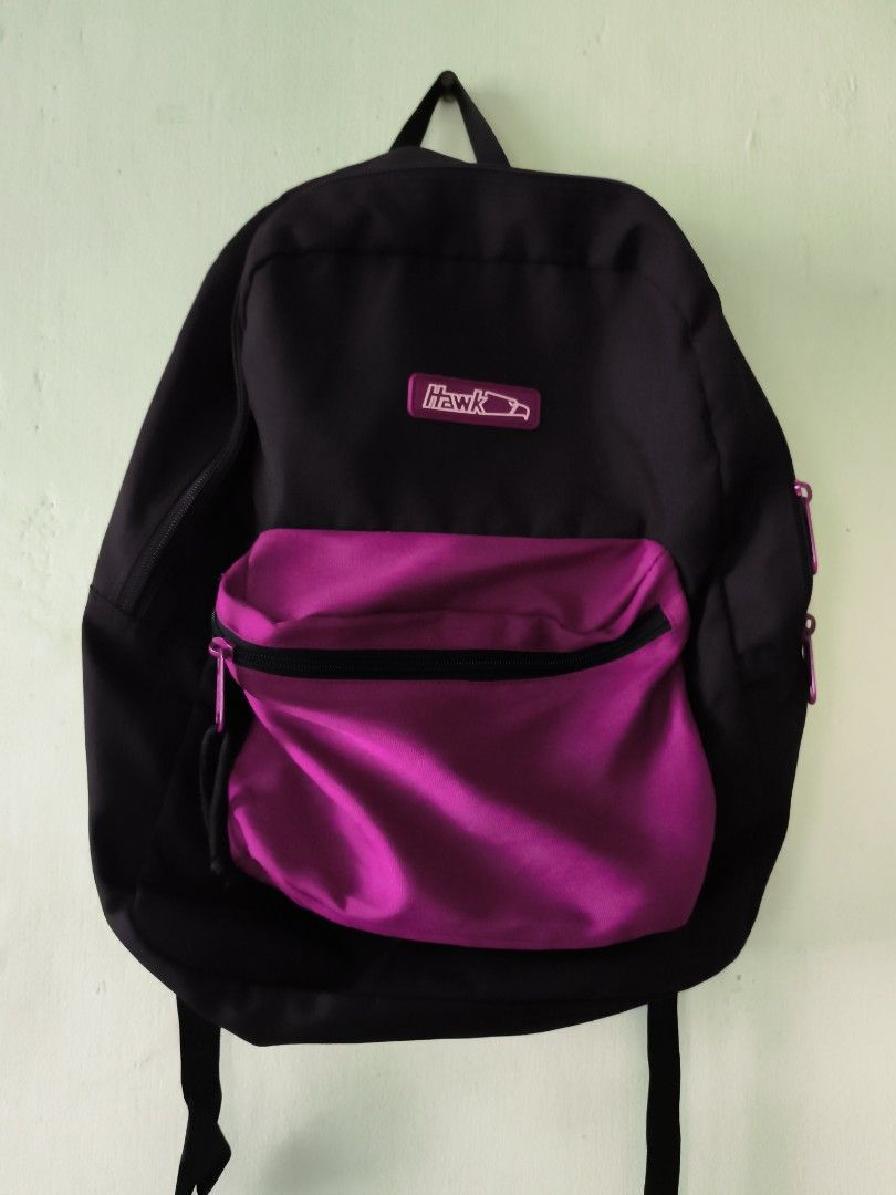 Hawk Black and Pink Backpack (Category: Backpacks) located in Bulacan. Submitted by jvblaguard08460 (Listing ID 1470750721, Image 1). Description: - Brand/Model: Hawk Backpack - Color: Classic black with a bright pink front pocket - Storage: Main compartment and front pocket with zipper closures - Comfort: Padded back straps for comfortable daily wear - Material: Durable fabric built to last - Use: Great size for school, work, or everyday commute