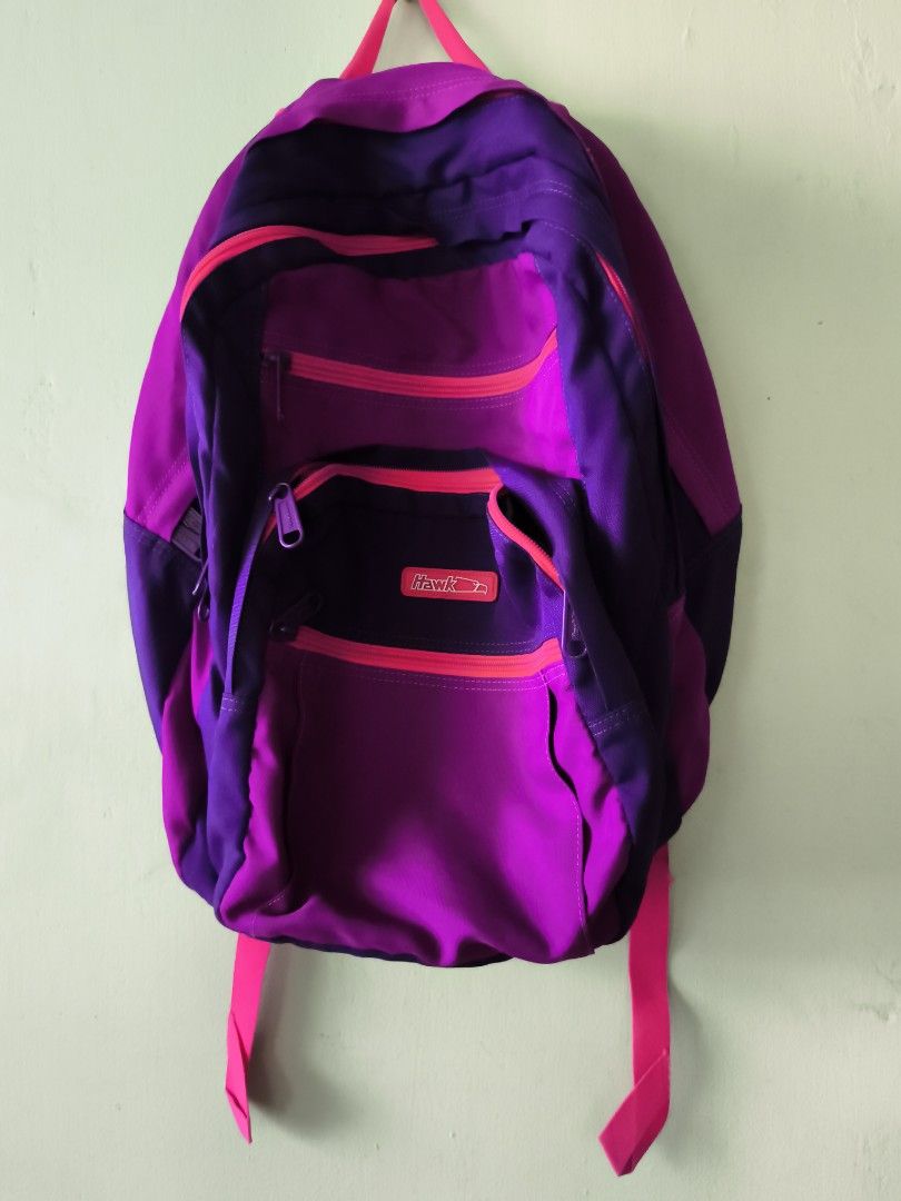 Hawk Purple and Pink School Backpack Bag (Category: Backpacks) located in Bulacan. Submitted by jvblaguard08460 (Listing ID 1470756754, Image 1). Description: - Brand: Hawk - Colorway: Purple and pink - Compartments: Multiple zipped front pockets and a spacious main interior - Interior: Durable patterned lining - Straps: Comfortable, padded pink shoulder straps with sturdy zippers and pull tabs - Condition: Clean inside and out - Ideal Use: Perfe
