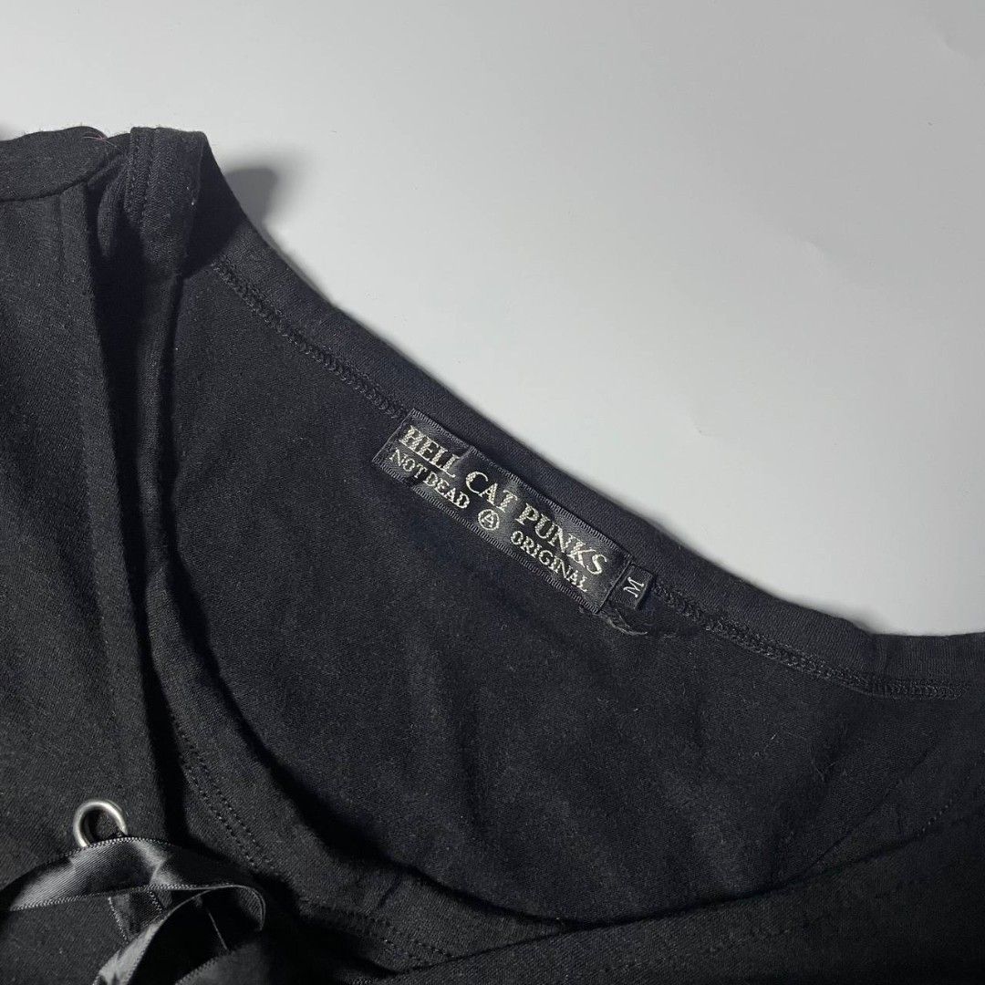 Hellcat Punks Black Corset Front Top Size M (Category: Blouses) located in Panabo. Submitted by moneyfckyaw (Listing ID 1470917278, Image 2). Description: - Brand: Hellcat Punks - Style Number: HCP-C397-01 - Size: M - Color: Black - Details: Front lace-up closure with ribbon ties and metal grommets, scoop neckline, short flared sleeves - Materials: Body is 60% polyester, 35% rayon, 5% polyurethane; Contrast & ribbon are 100% polyester - Origin: M
