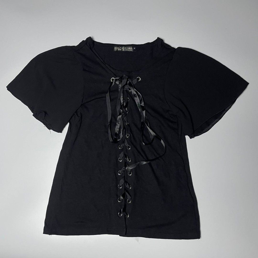 Hellcat Punks Black Corset Front Top Size M (Category: Blouses) located in Panabo. Submitted by moneyfckyaw (Listing ID 1470917278, Image 1). Description: - Brand: Hellcat Punks - Style Number: HCP-C397-01 - Size: M - Color: Black - Details: Front lace-up closure with ribbon ties and metal grommets, scoop neckline, short flared sleeves - Materials: Body is 60% polyester, 35% rayon, 5% polyurethane; Contrast & ribbon are 100% polyester - Origin: M