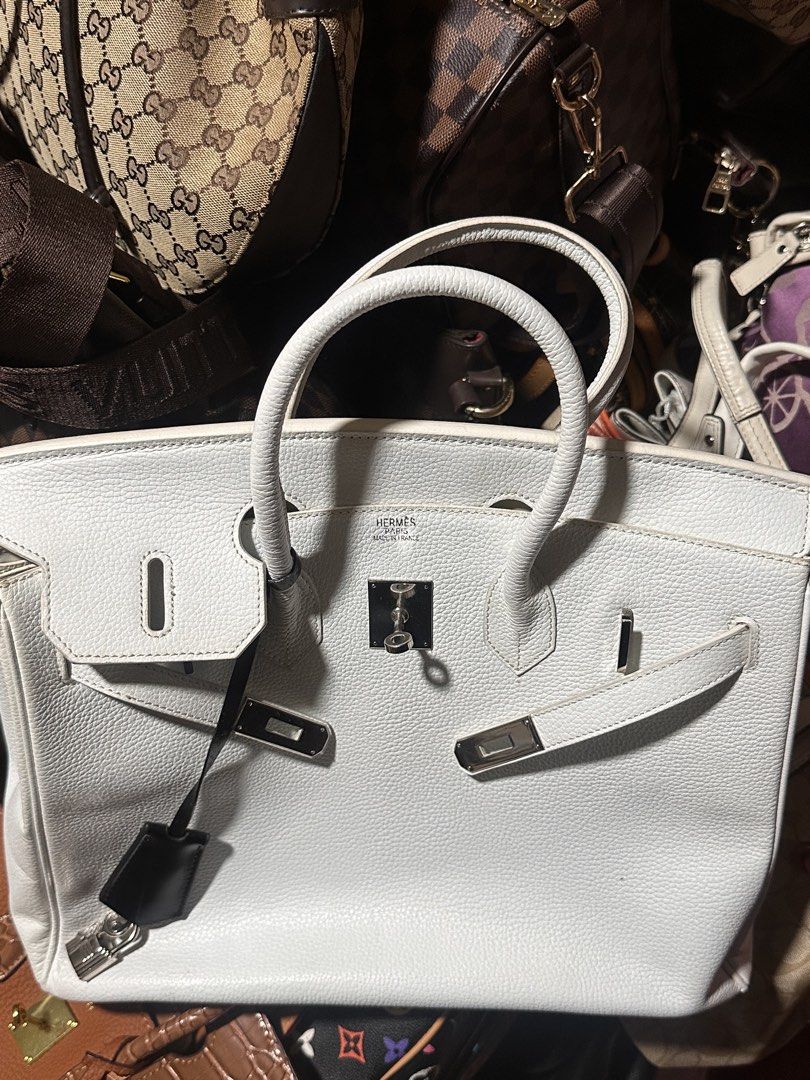 Hermes Birkin White Leather Handbag (Category: Luxury Bags & Wallets) located in Manila. Submitted by saturnina89 (Listing ID 1470831622, Image 1). Description: - Material: Premium white pebbled textured grain leather with tonal stitching - Hardware: Sleek silver-tone hardware - Closure & Security: Front flap with straps, includes a functional padlock and clochette - Handles: Sturdy double top handles for easy carrying - Interior/Base: Clean, str