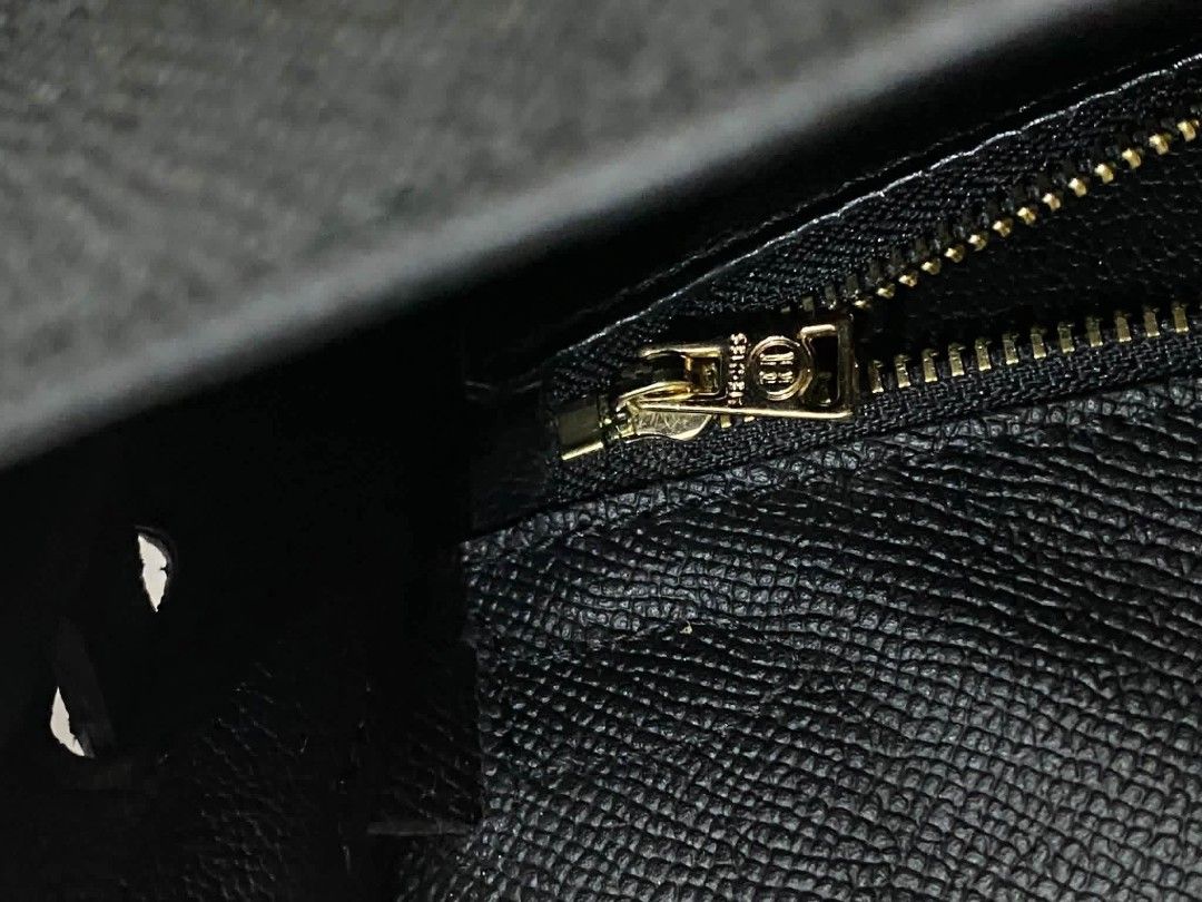 Hermes Black Leather Kelly Handbag (Category: Luxury Bags & Wallets) located in Manila. Submitted by zenbear_6b2d8a (Listing ID 1470760064, Image 3). Description: - Brand: Hermès Kelly - Material: Black textured leather - Hardware: Premium gold-toned hardware with 'Hermès Paris Made in France' stamp - Design: Top handle, front flap closure with straps, and turnlock fastening - Interior: Includes a convenient zippered pocket - Extras: Comes with a