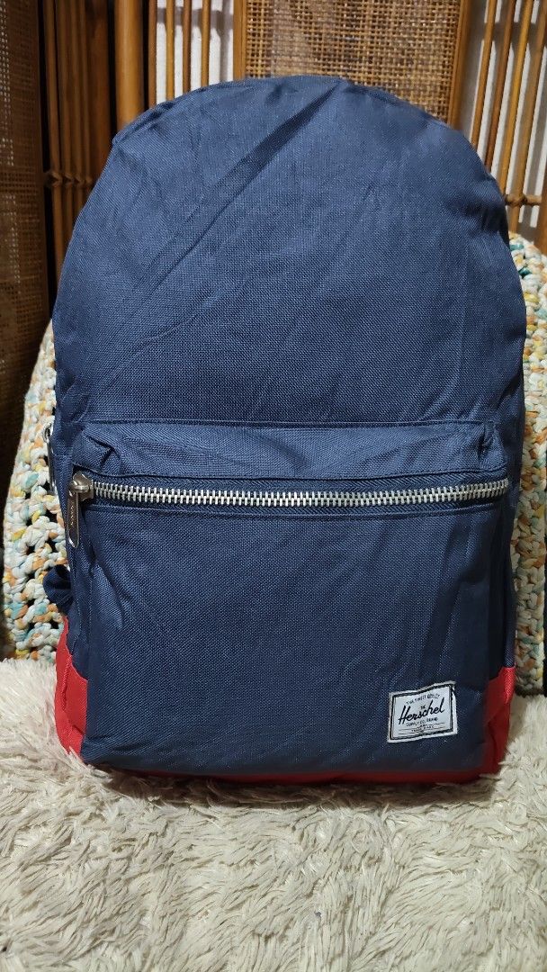 Herschel Blue Backpack with Red Stripe Lining (Category: Backpacks) located in Cebu City. Submitted by lumaynojes00490 (Listing ID 1470872123, Image 1). Description: - Color: Navy blue - Material: Durable canvas exterior with signature red and white striped fabric lining - Storage: Large main zipper compartment that opens wide - Organization: Built-in inner pocket sleeve - Comfort: Padded black shoulder straps for easy carrying.