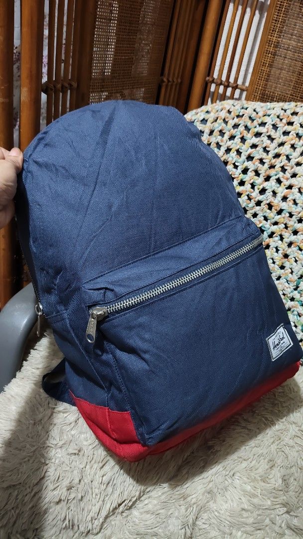 Herschel Blue Backpack with Red Stripe Lining (Category: Backpacks) located in Cebu City. Submitted by lumaynojes00490 (Listing ID 1470872123, Image 2). Description: - Color: Navy blue - Material: Durable canvas exterior with signature red and white striped fabric lining - Storage: Large main zipper compartment that opens wide - Organization: Built-in inner pocket sleeve - Comfort: Padded black shoulder straps for easy carrying.